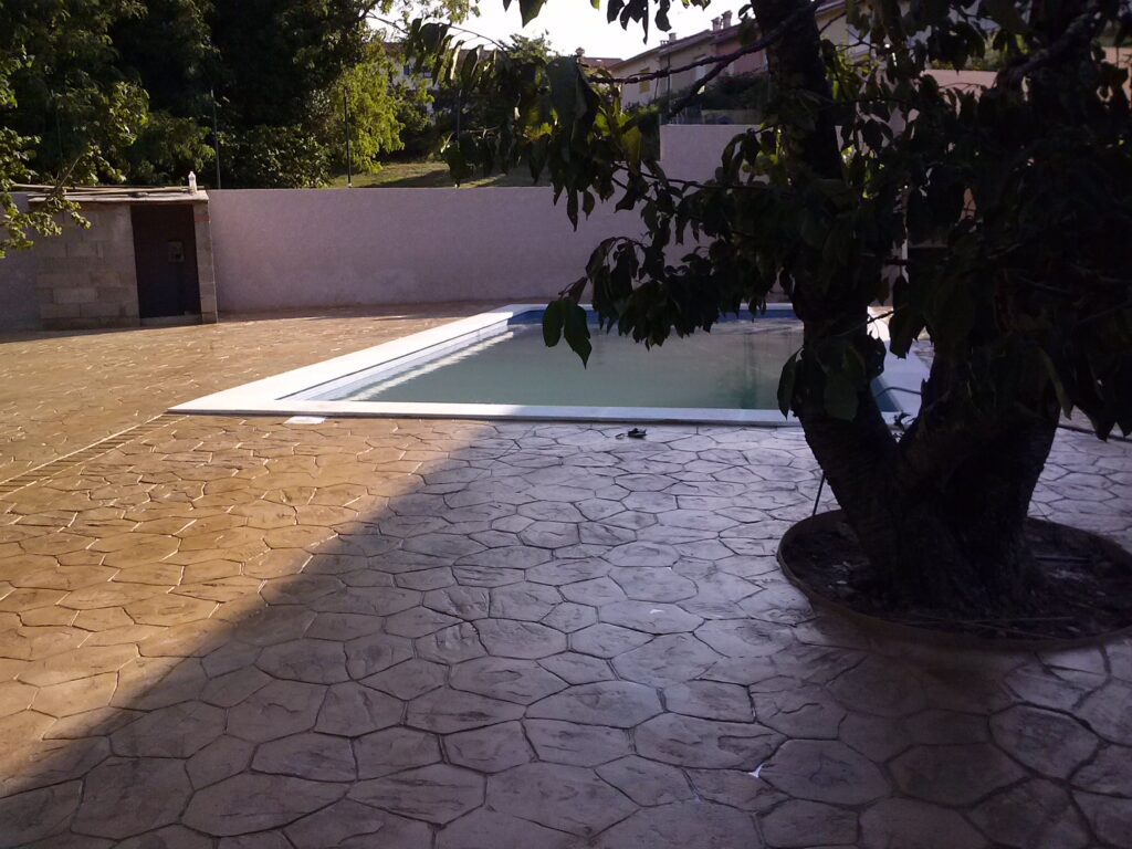Aménagement d’une plage de piscine en béton imprimé effet pierre